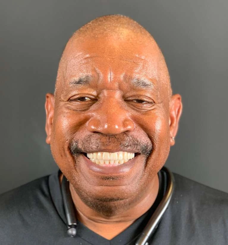 Patient smiling with a non-removable All-on-X implant restoration