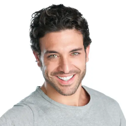 Smiling man in a gray T-shirt showing a bright, healthy smile
