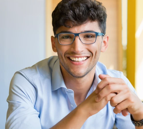 Smiling man in glasses considering mini dental implants