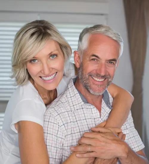 Smiling middle-aged couple with healthy teeth