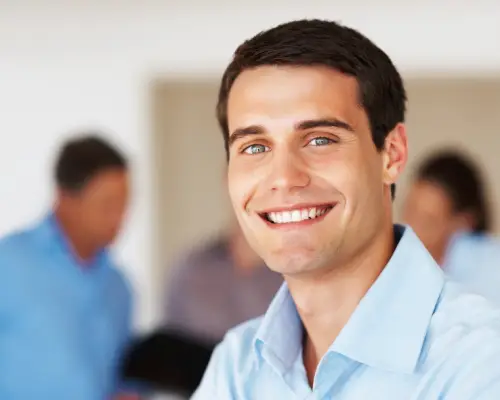 Smiling young man in a light blue shirt